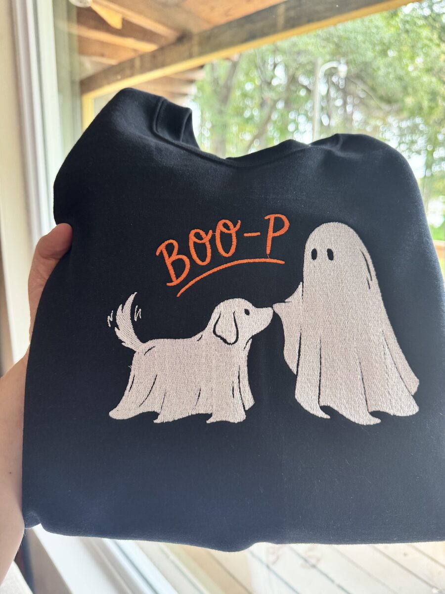 Black crewneck sweatshirt embroidered with Boo-P in orange script, a ghost, and a dog