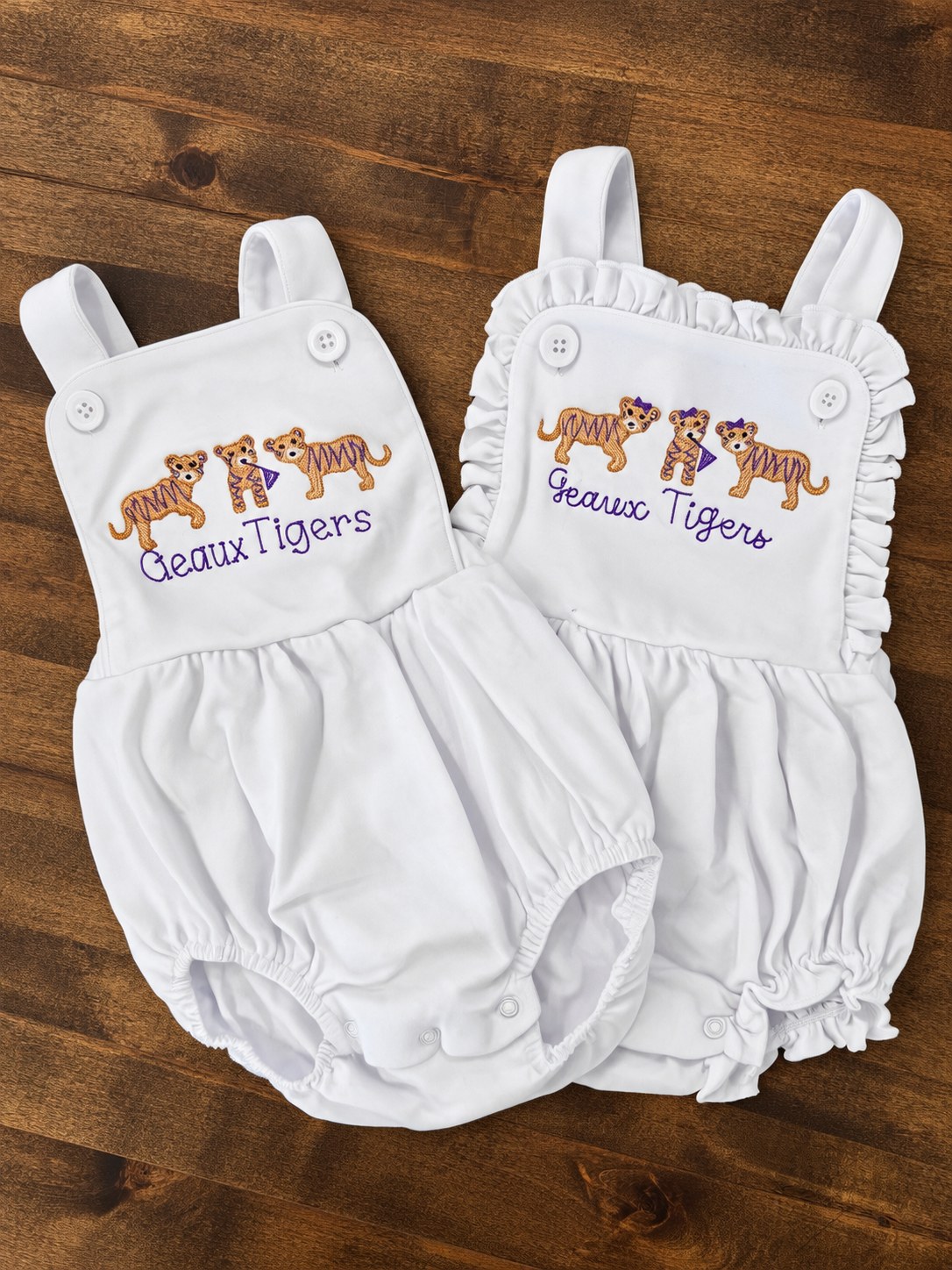 Two white Geaux Tigers embroidered baby bubble sunsuits with tiger cubs design