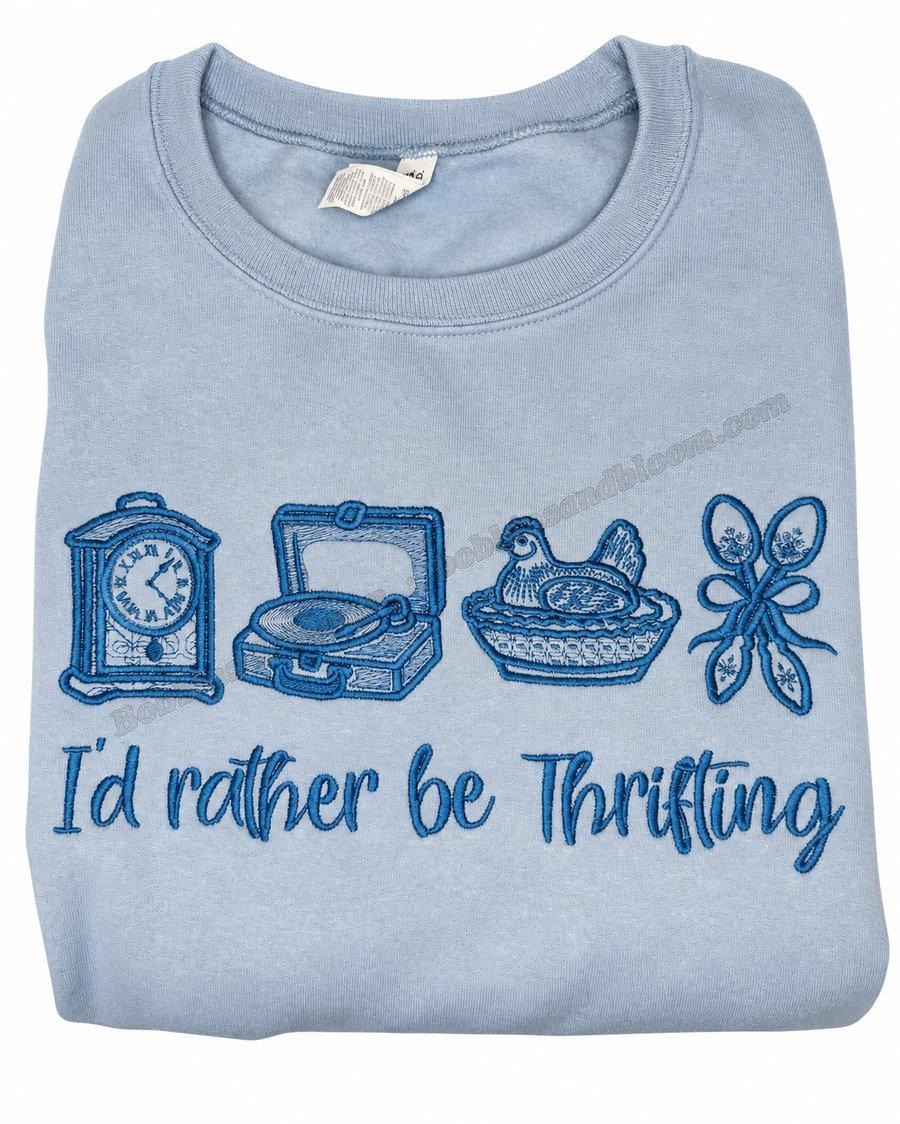 Light blue sweatshirt embroidered with a clock, record player, hen dish, and ribbon, and the words I'd rather be Thrifting